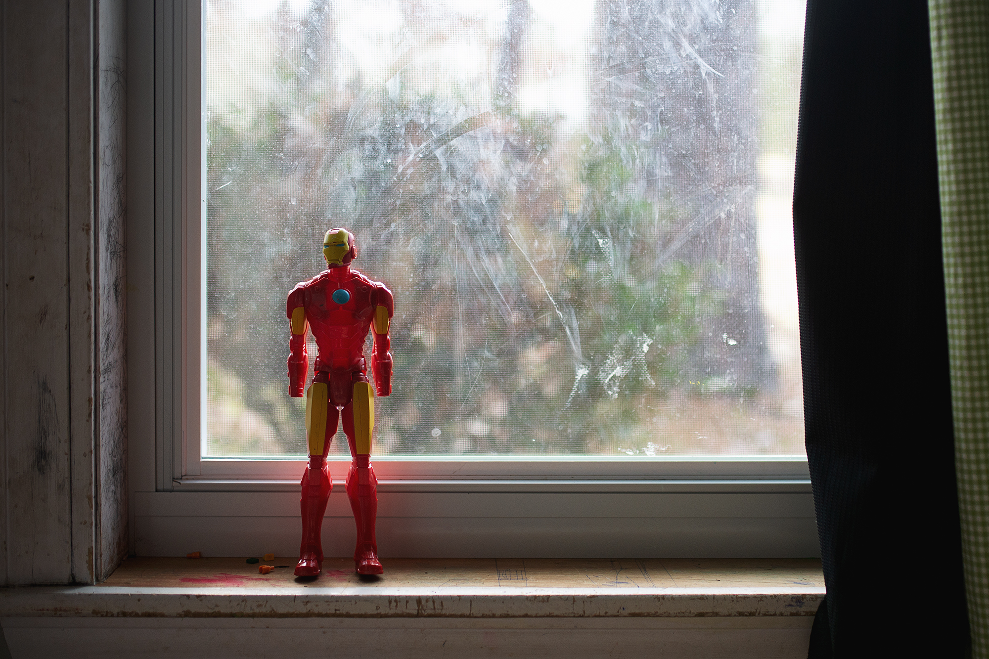 action figure in window - documentary family photography