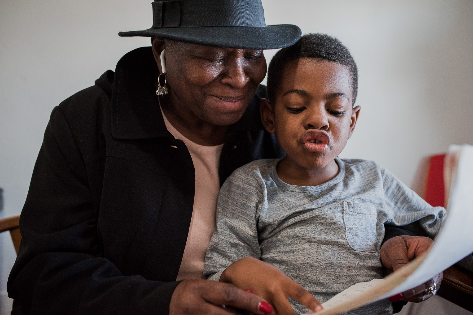 boy reading to woman - documentary family photography