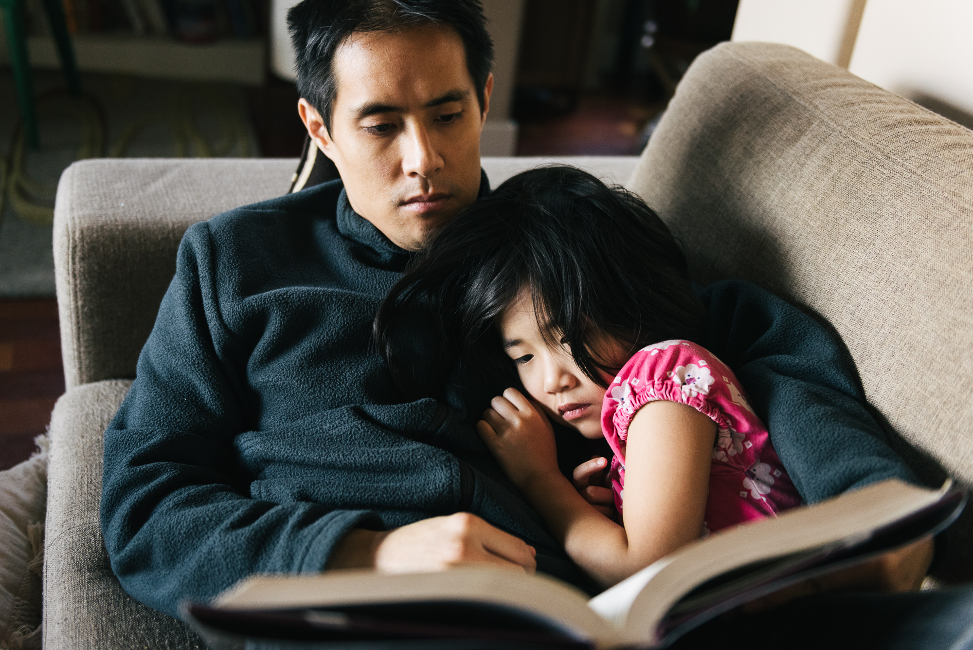 girl snuggling with father - documentary family photography