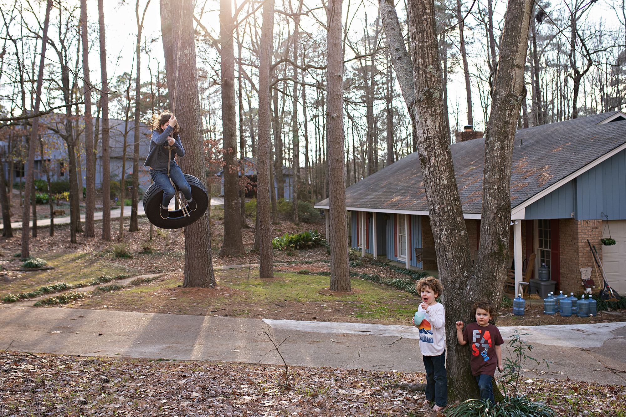 kids playing on tire swing - documentary family photography