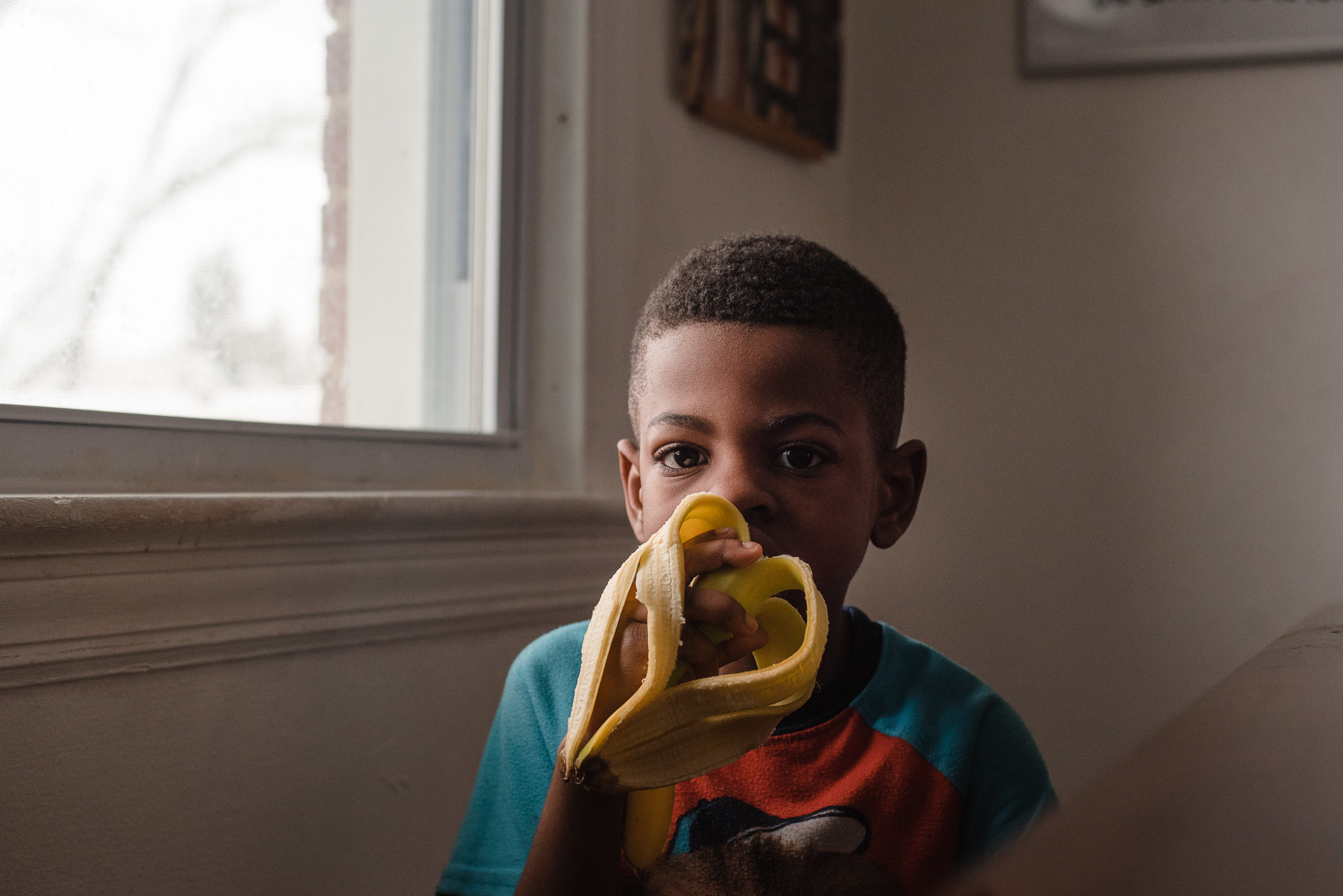 boy eating banana - documentary family photography