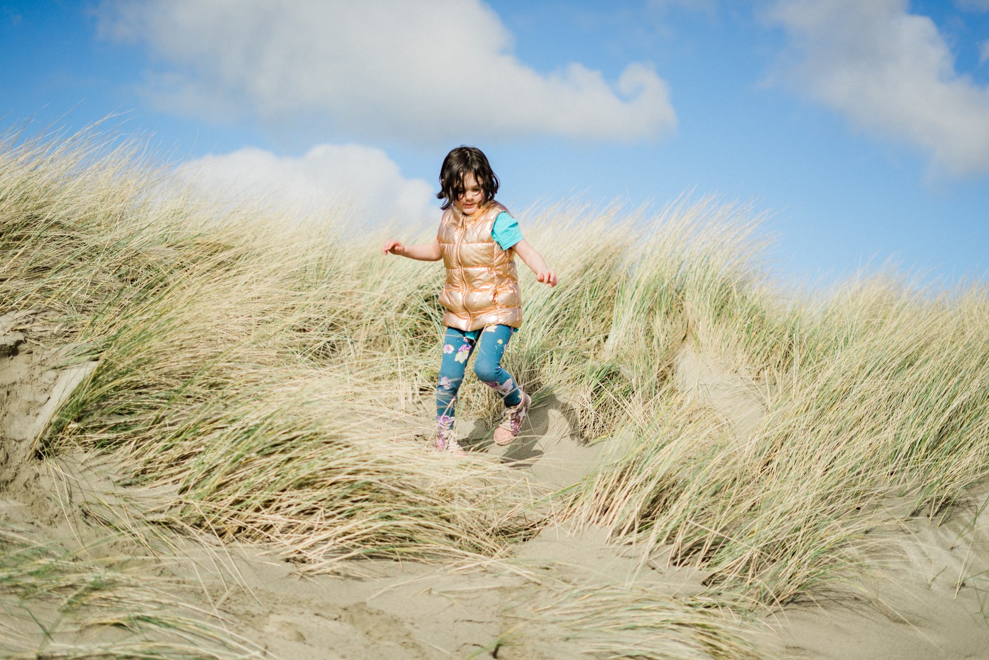 child in wild grass with costume - documentary family photography