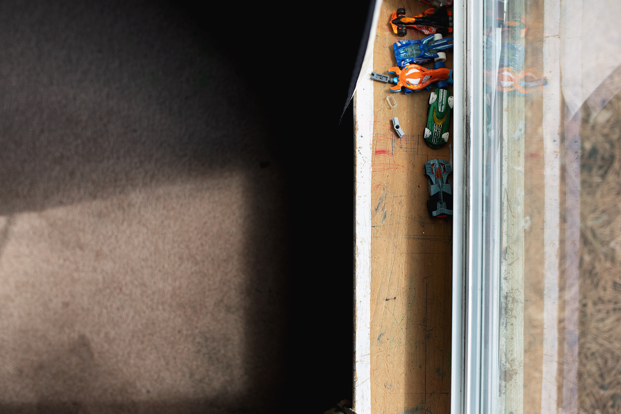 toys on window sill - documentary family photography