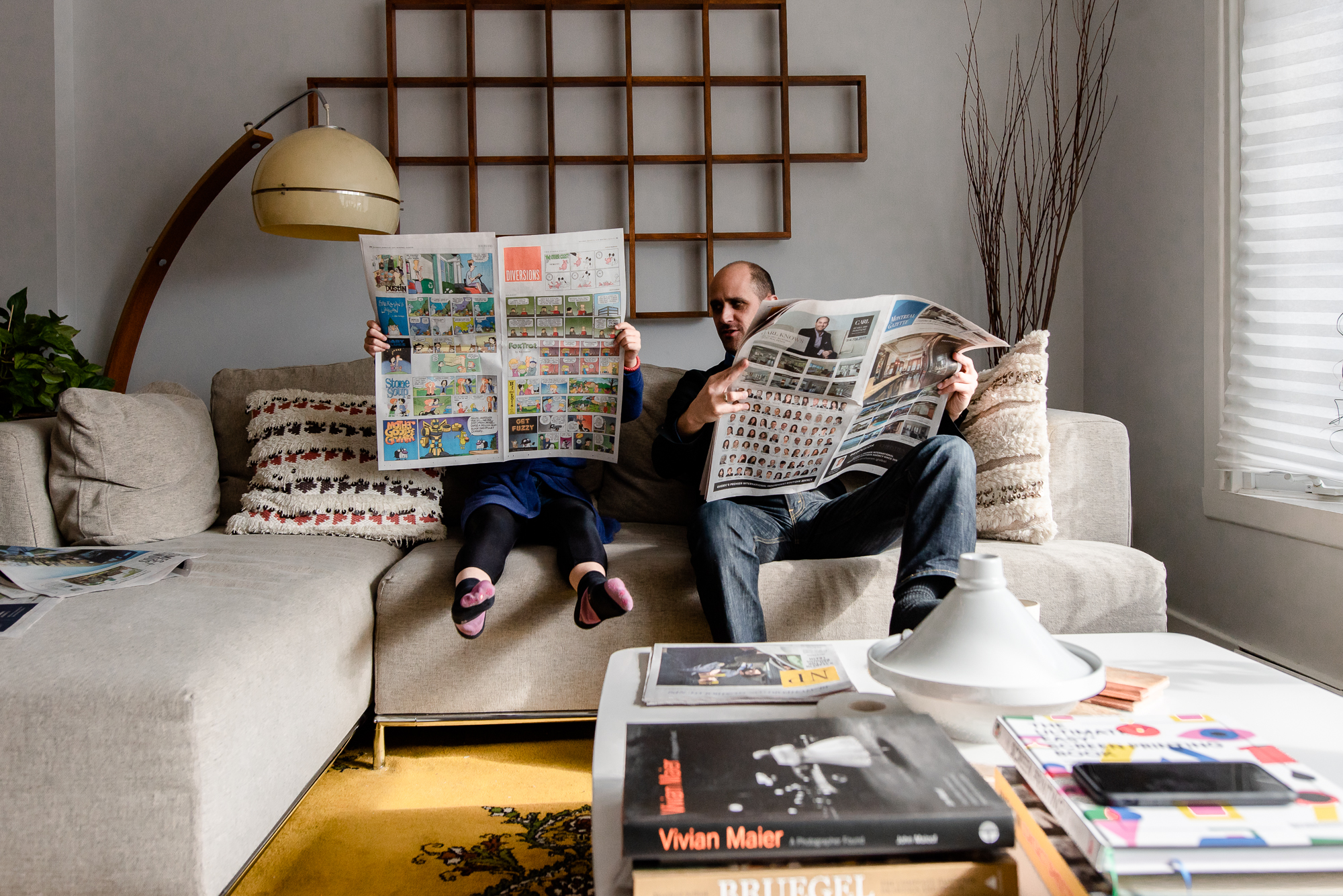 father and daughter reading the newspaper