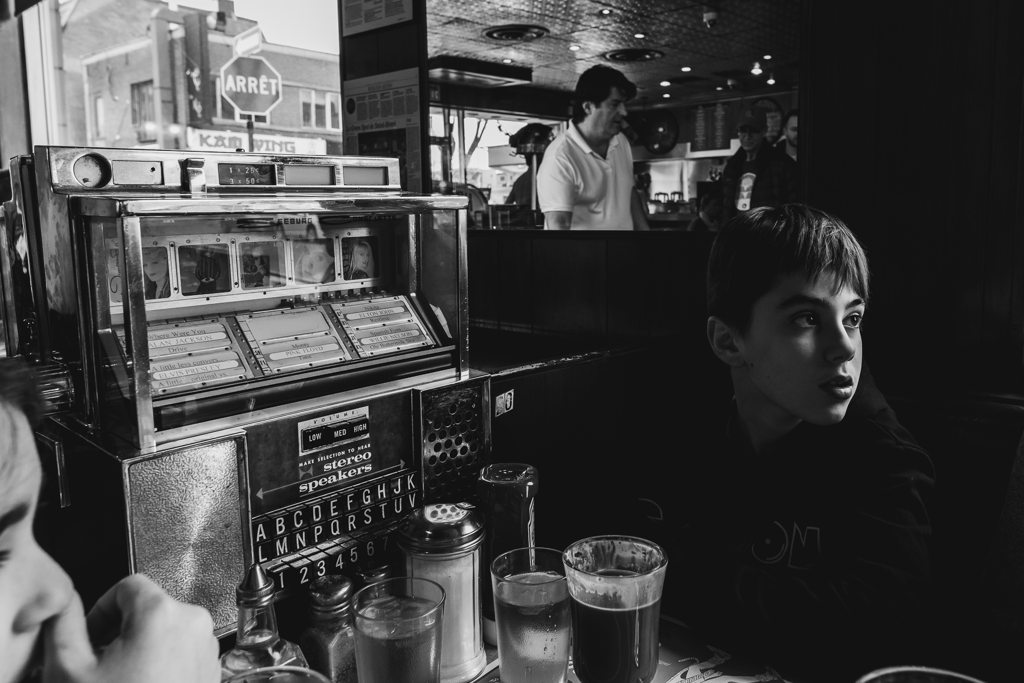 boy at table next to jukebox - documentary family photography