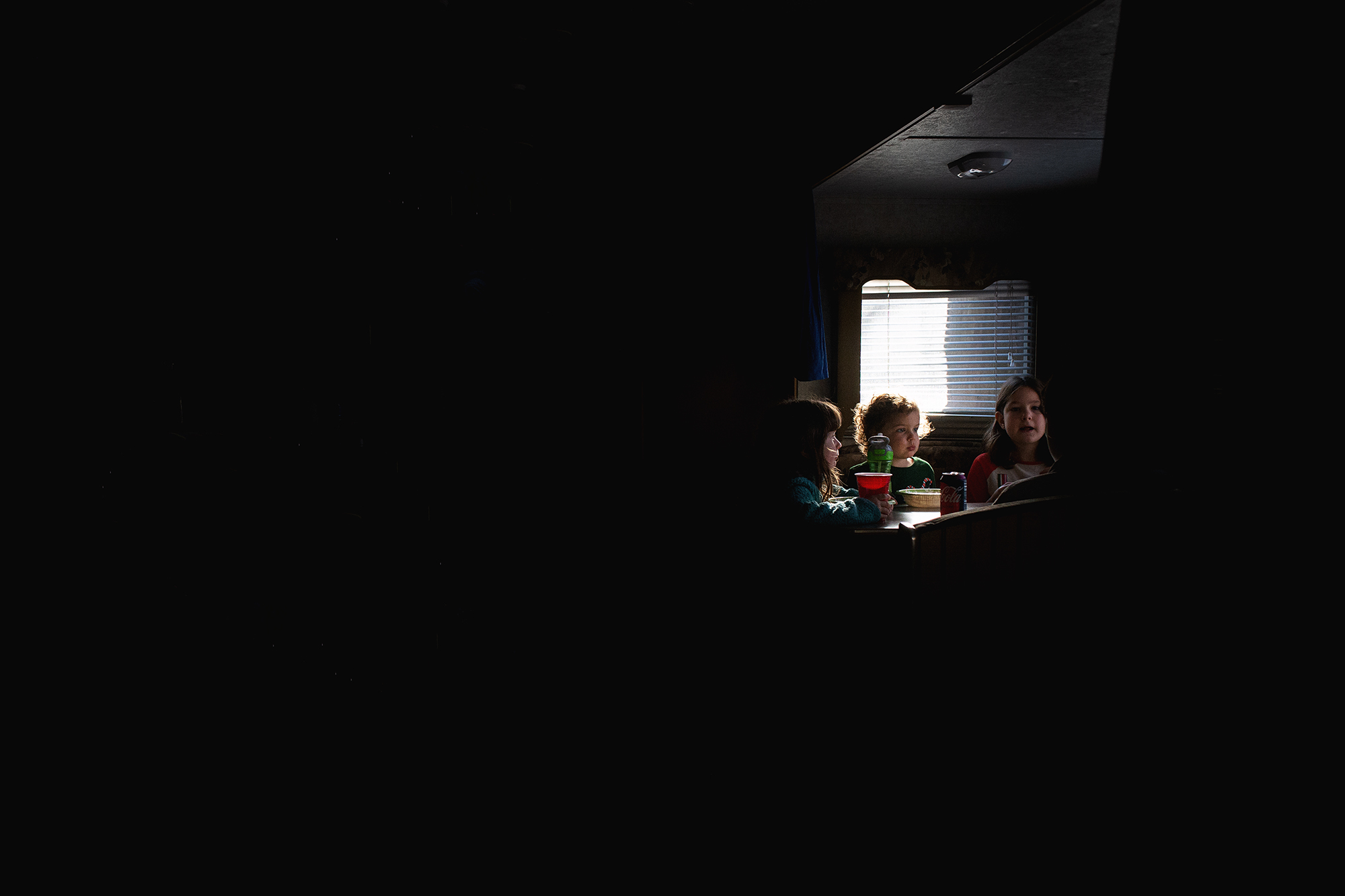 kids at dining table in camper - documentary family photography