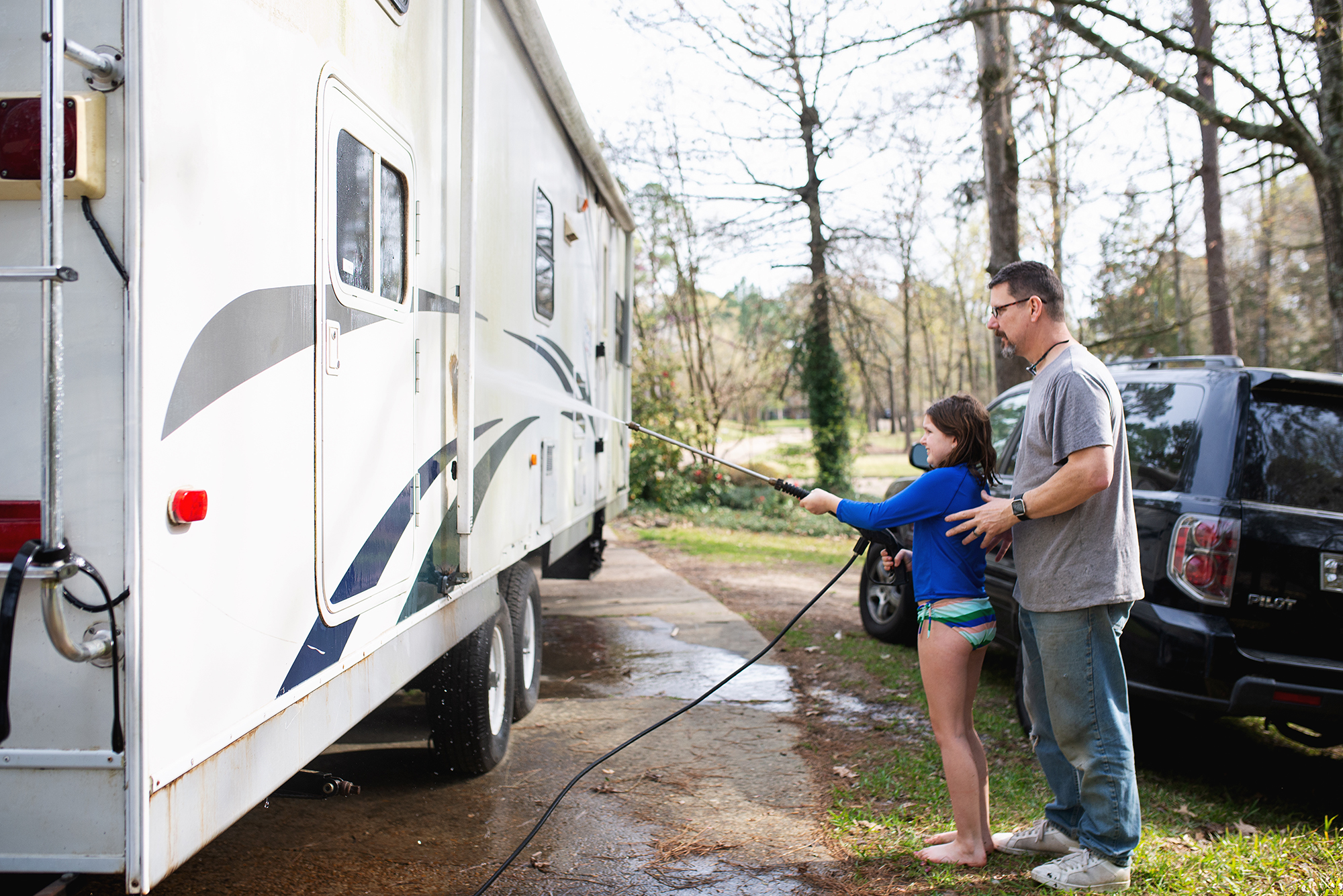father and daughter washing camper - documentary family photography