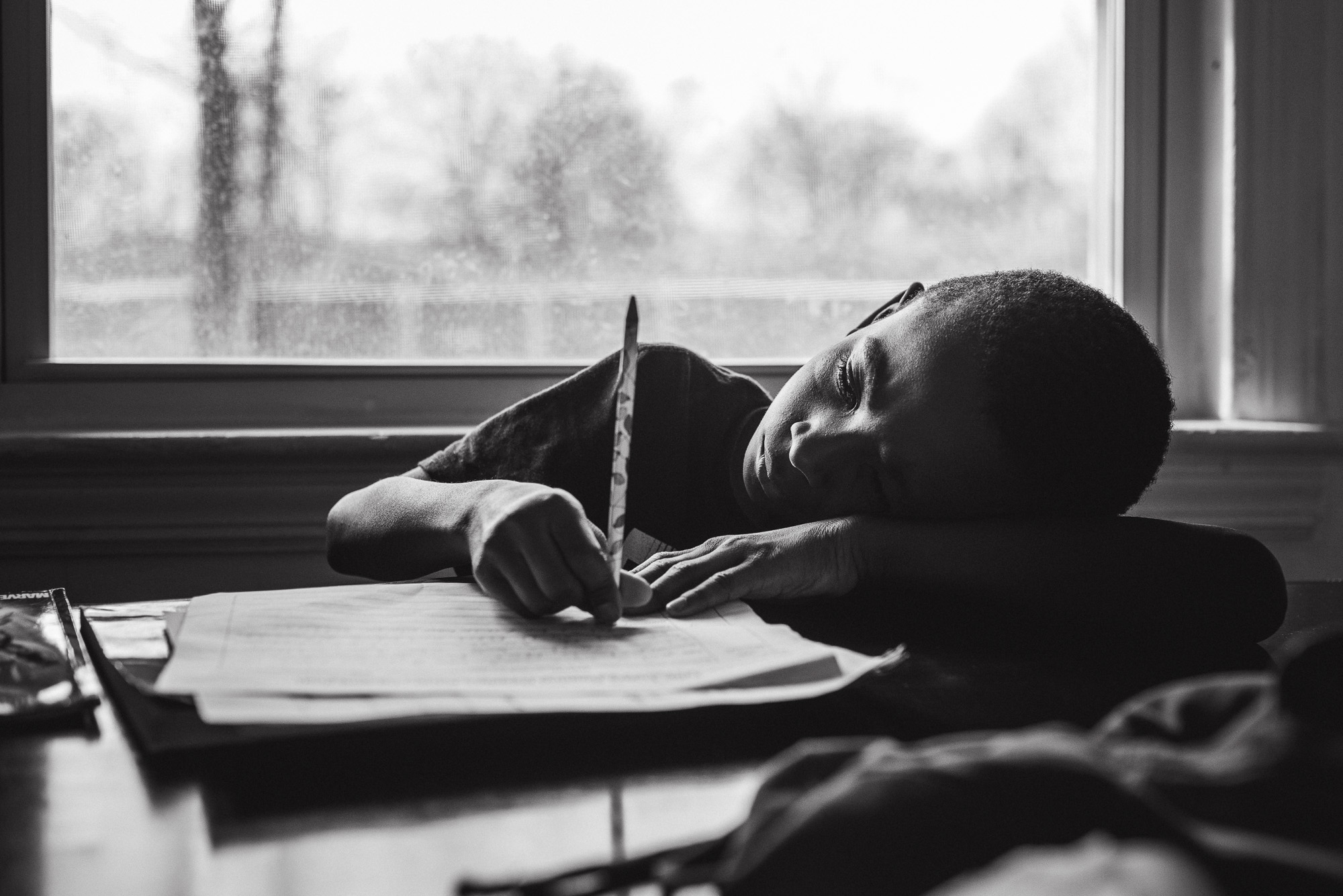 boy doing homework - documentary family photography