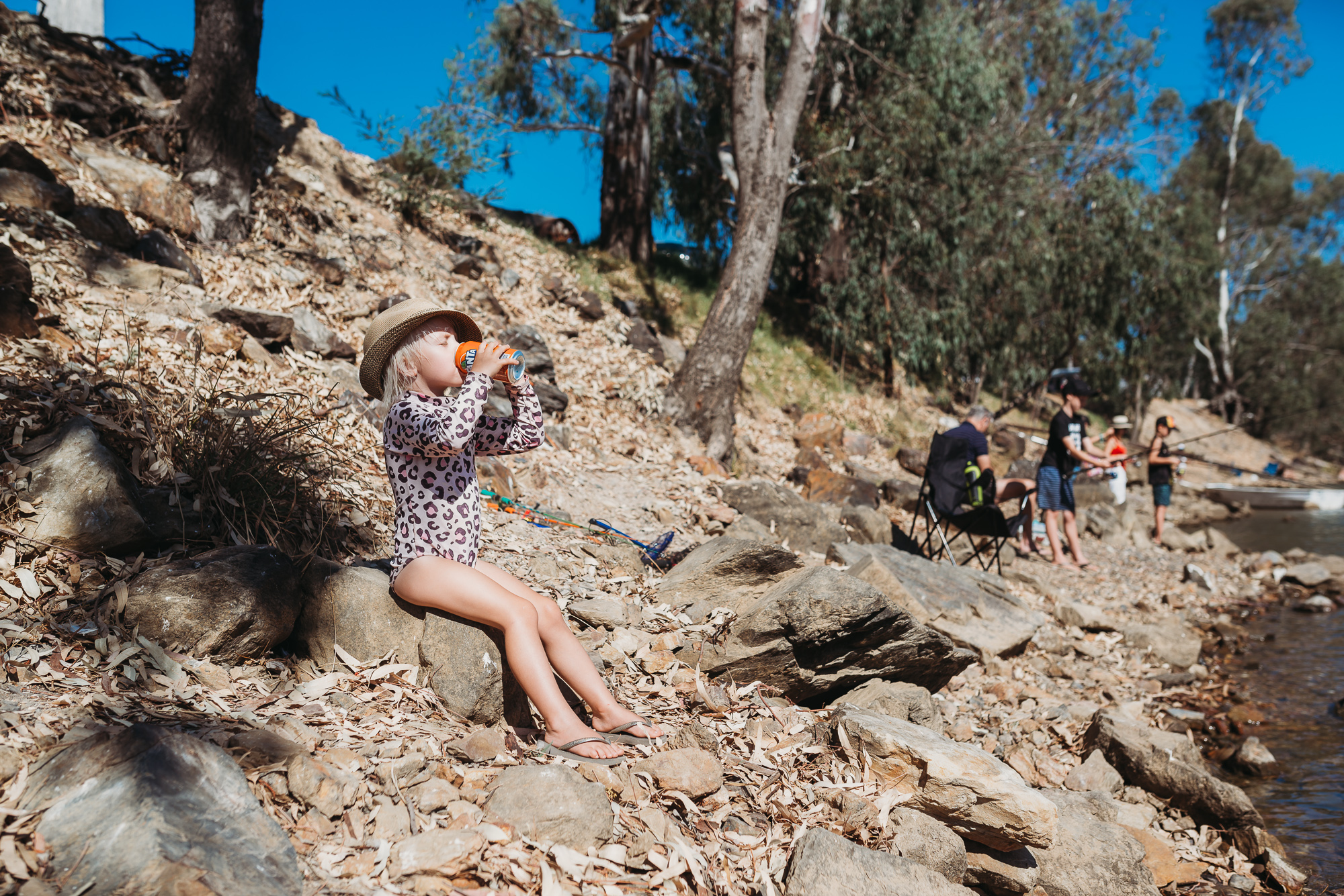 child sitting on rocks - documentary family photography