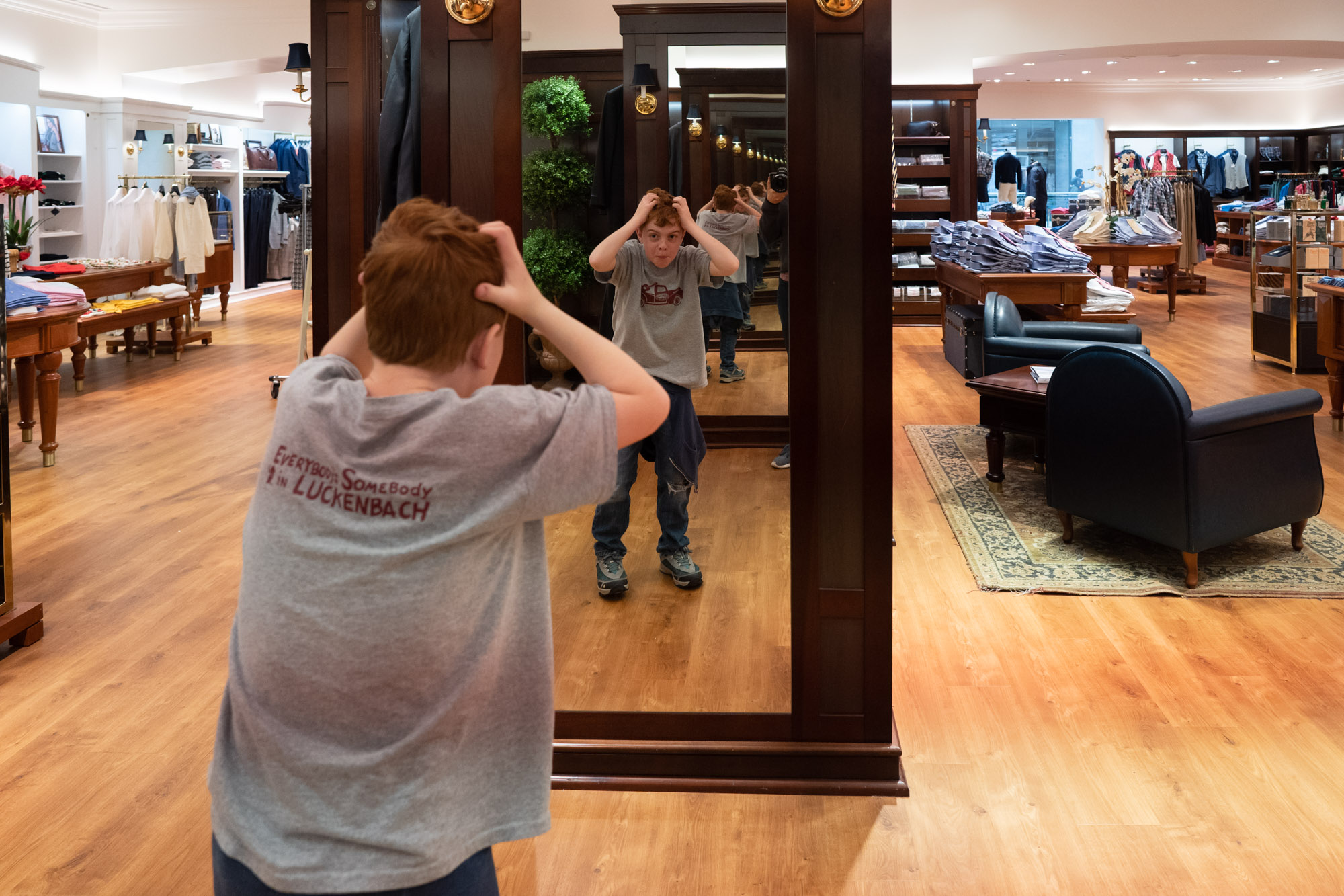 boy making face in mirror - documentary family photography