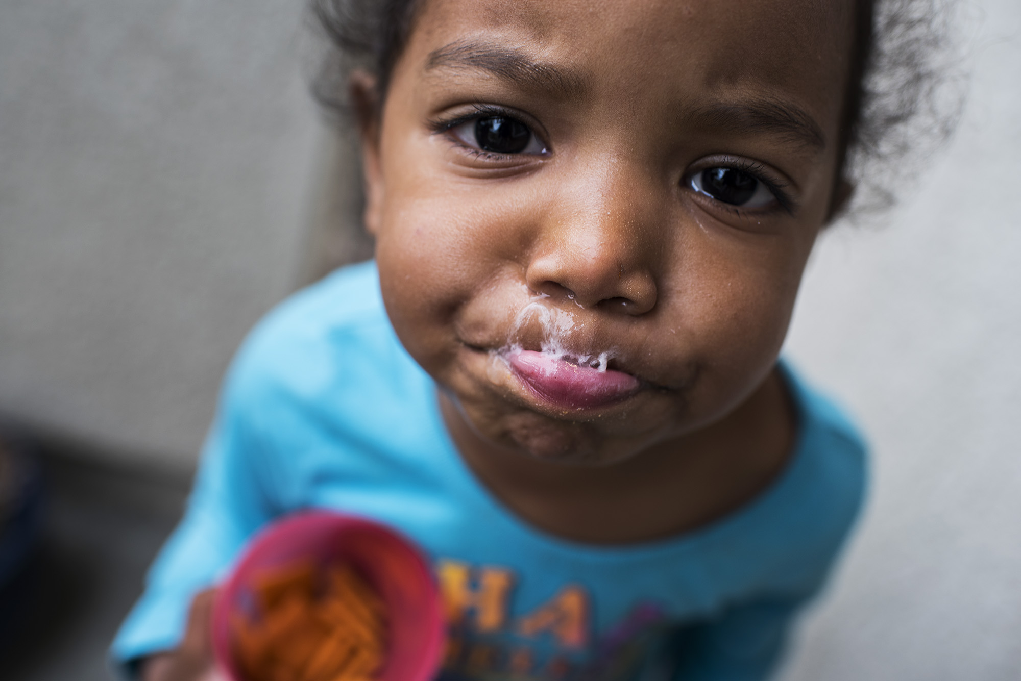 girl blowing spit bubbles - documentary family photography