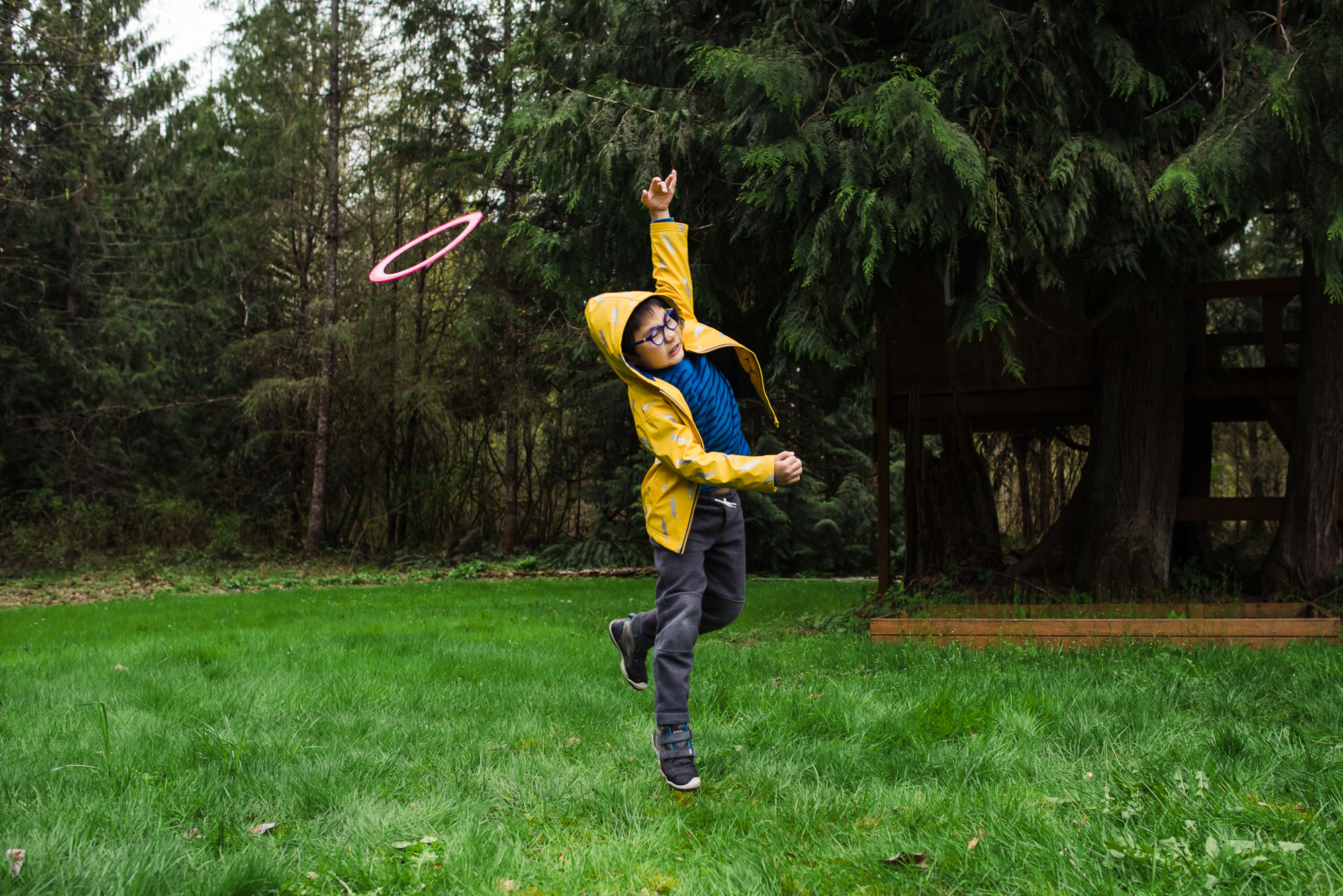 boy reaches for frisbee - documentary family photography