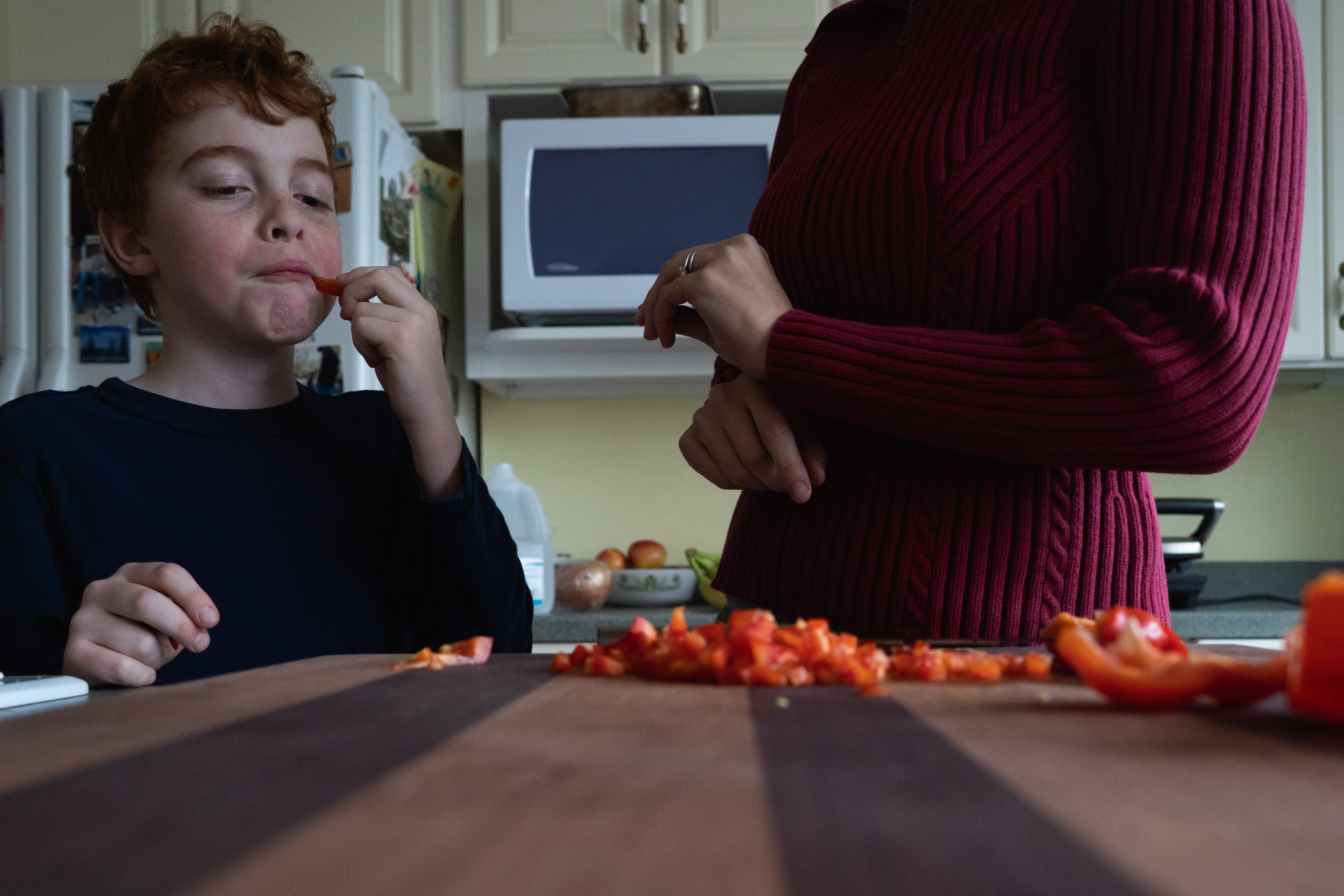 boy eating tomatoes - documentary family photography