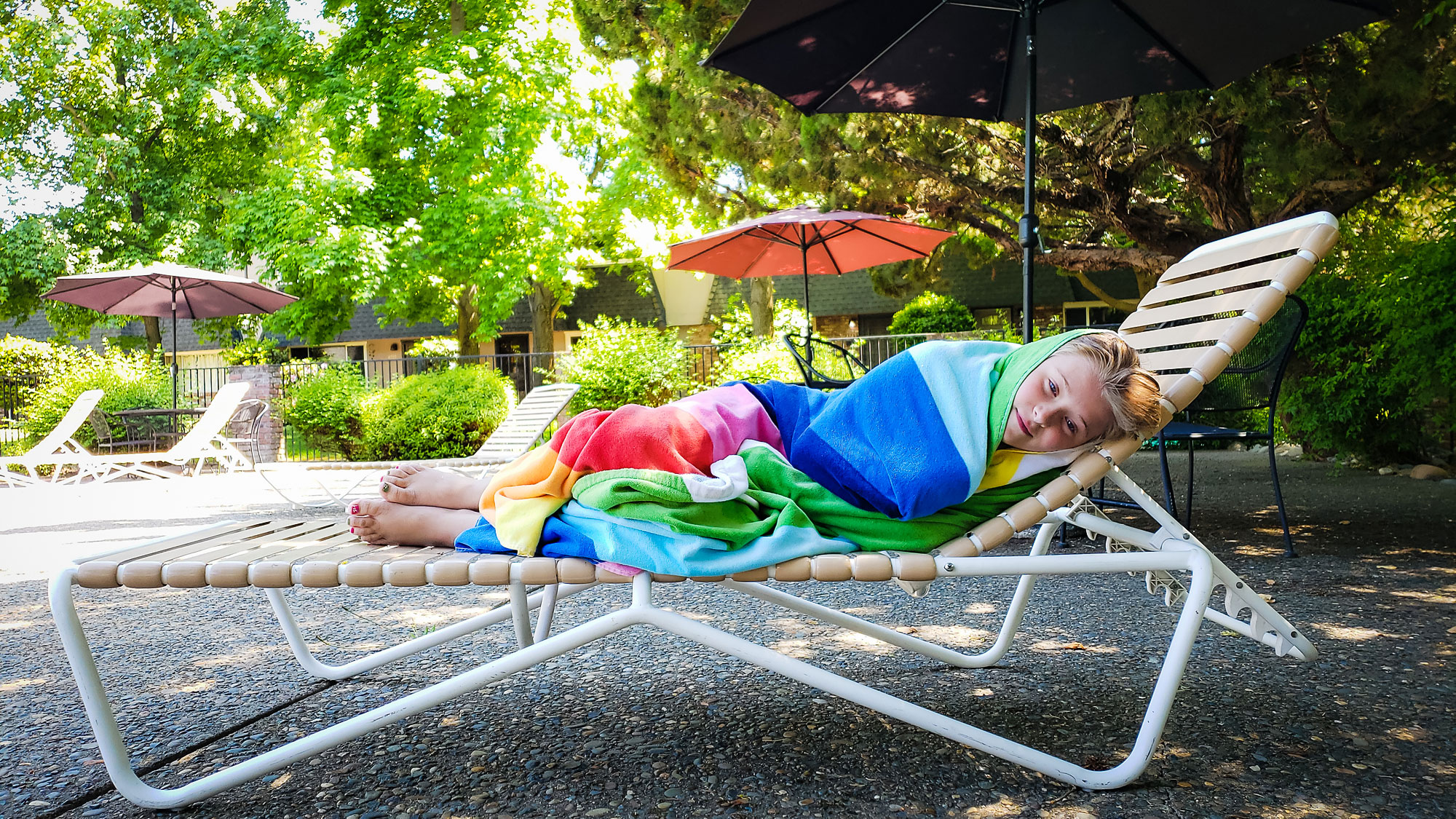 girl laying on lawn chair - documentary family photography