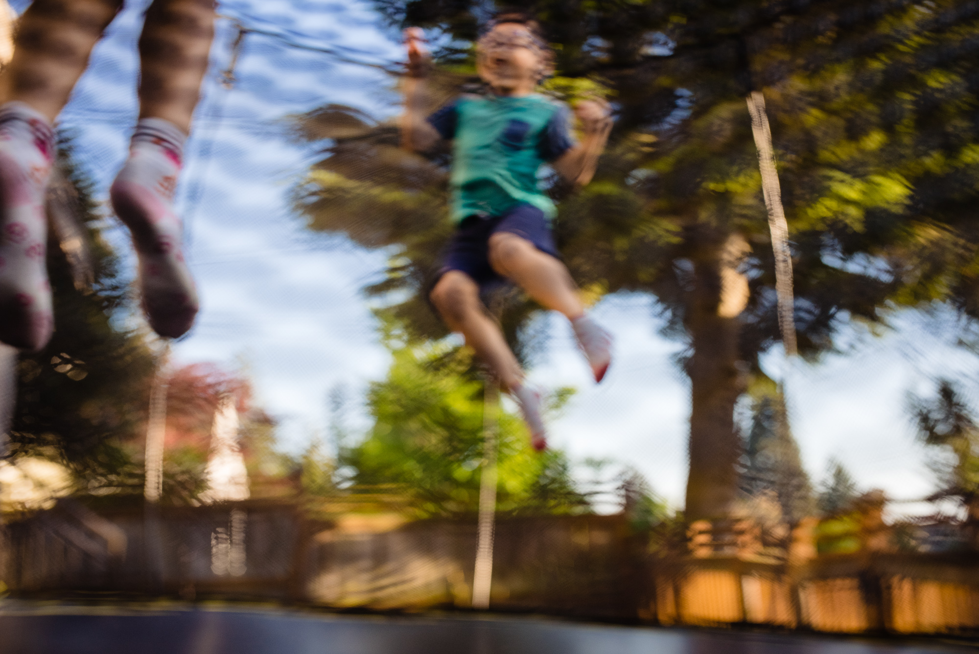 kid jumping on trampoline documentary family photography