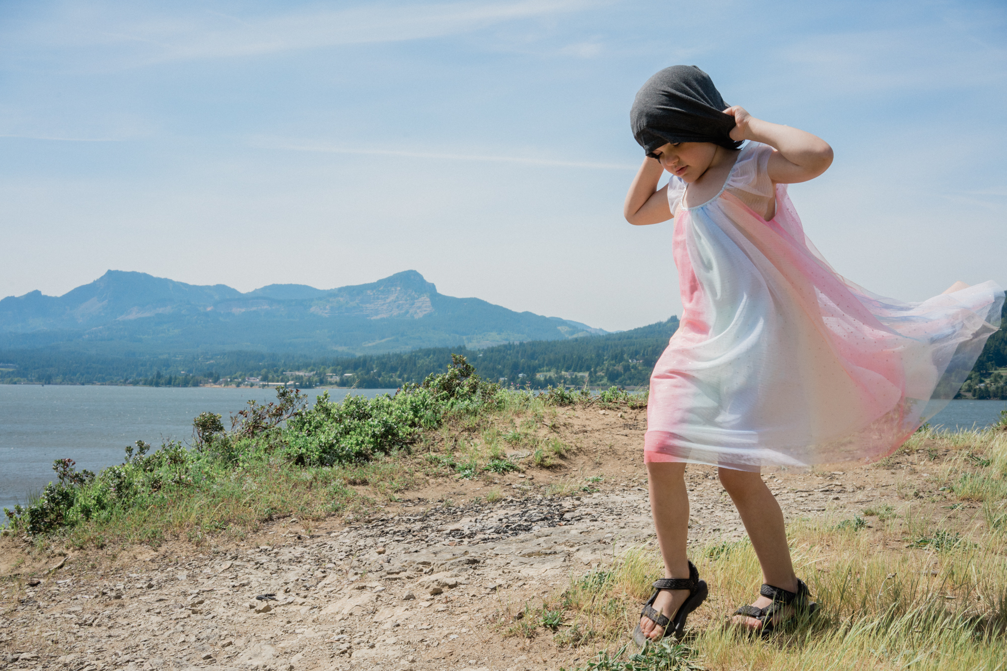 girl in dress on windy coastline - documentary family photography