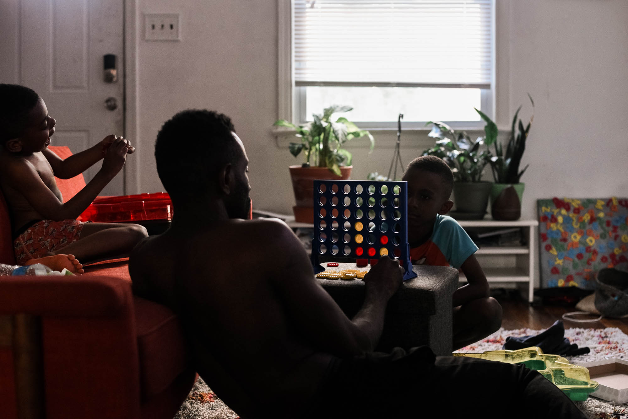 father and son playing board game - documentary family photography