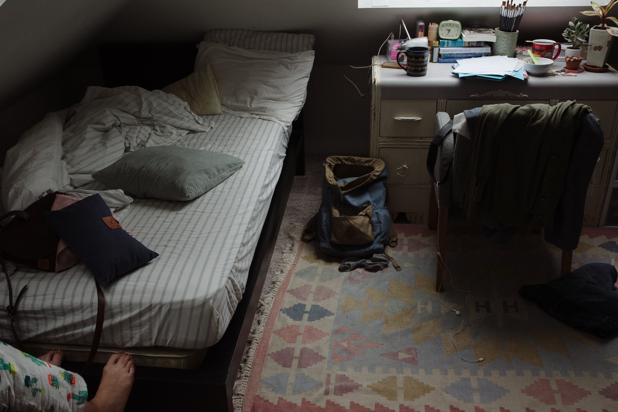 backpack on bedroom floor - documentary family photography