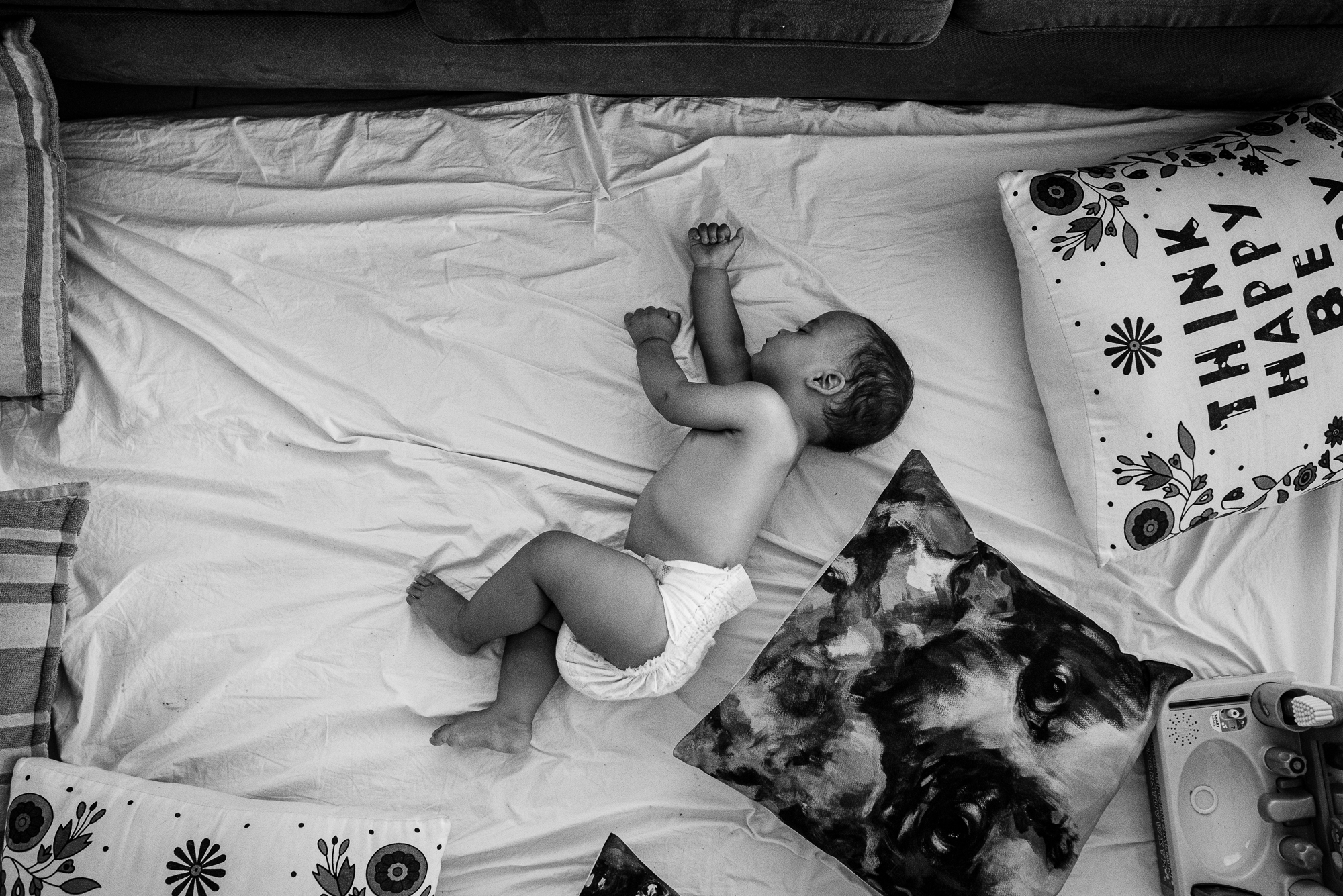 baby asleep on bed - documentary family photography