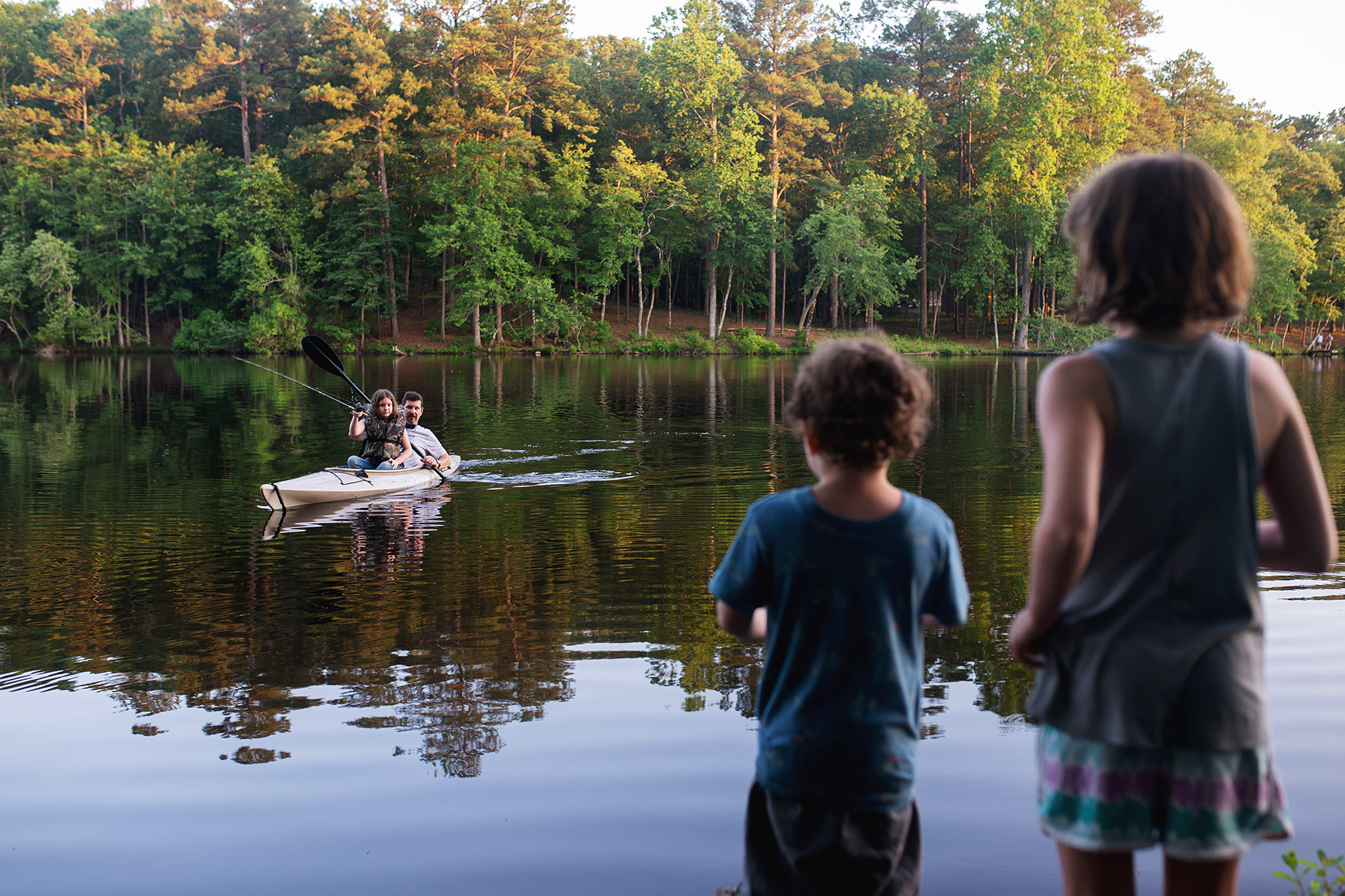 kids watch people on lake - documentary family photography