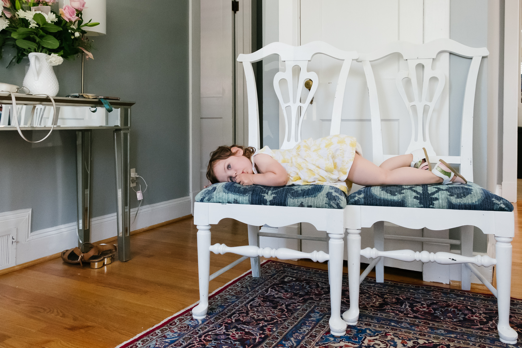 tired girl on chairs - documentary family photography