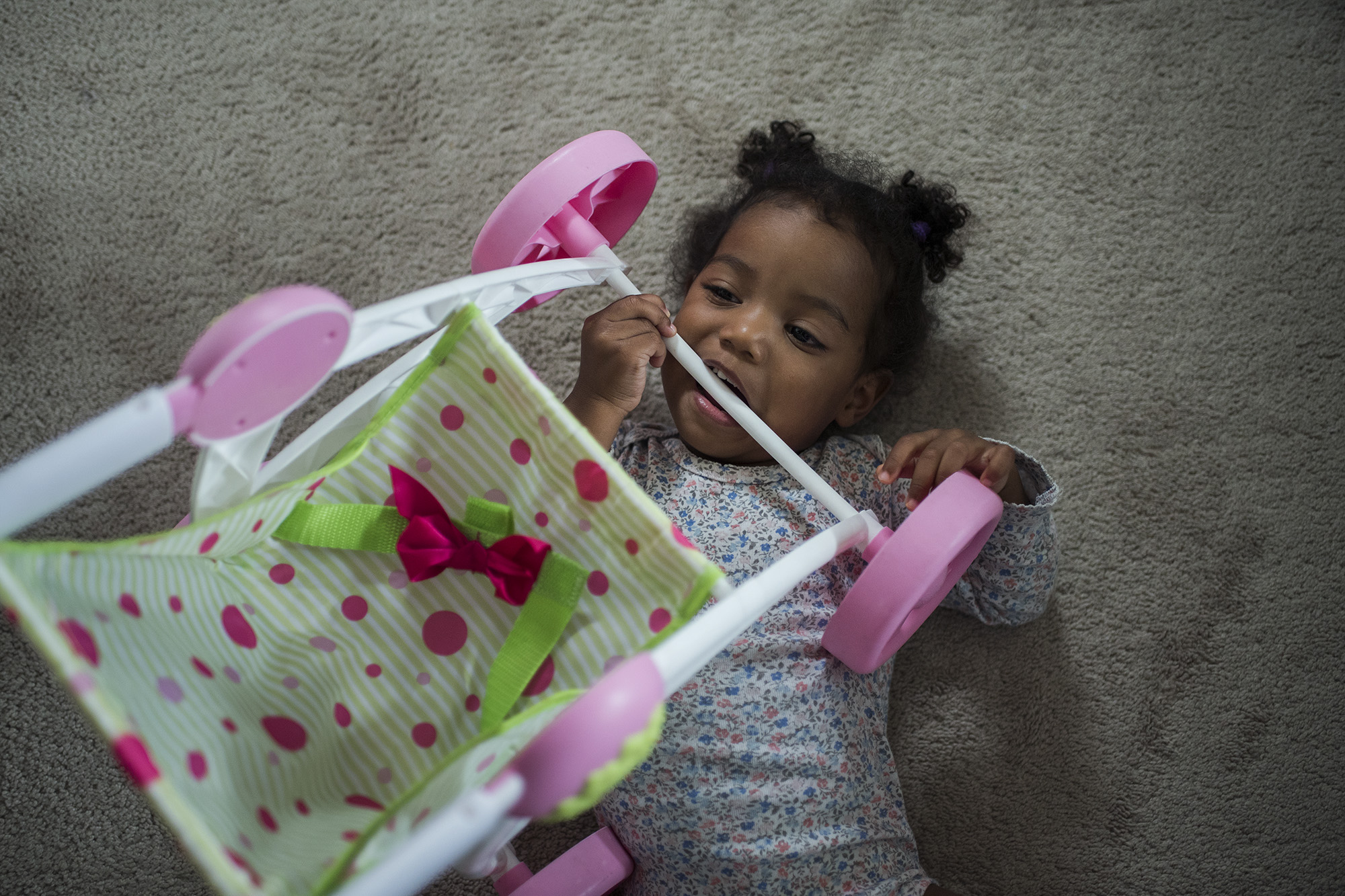 baby chewing on stroller -documentary family photography