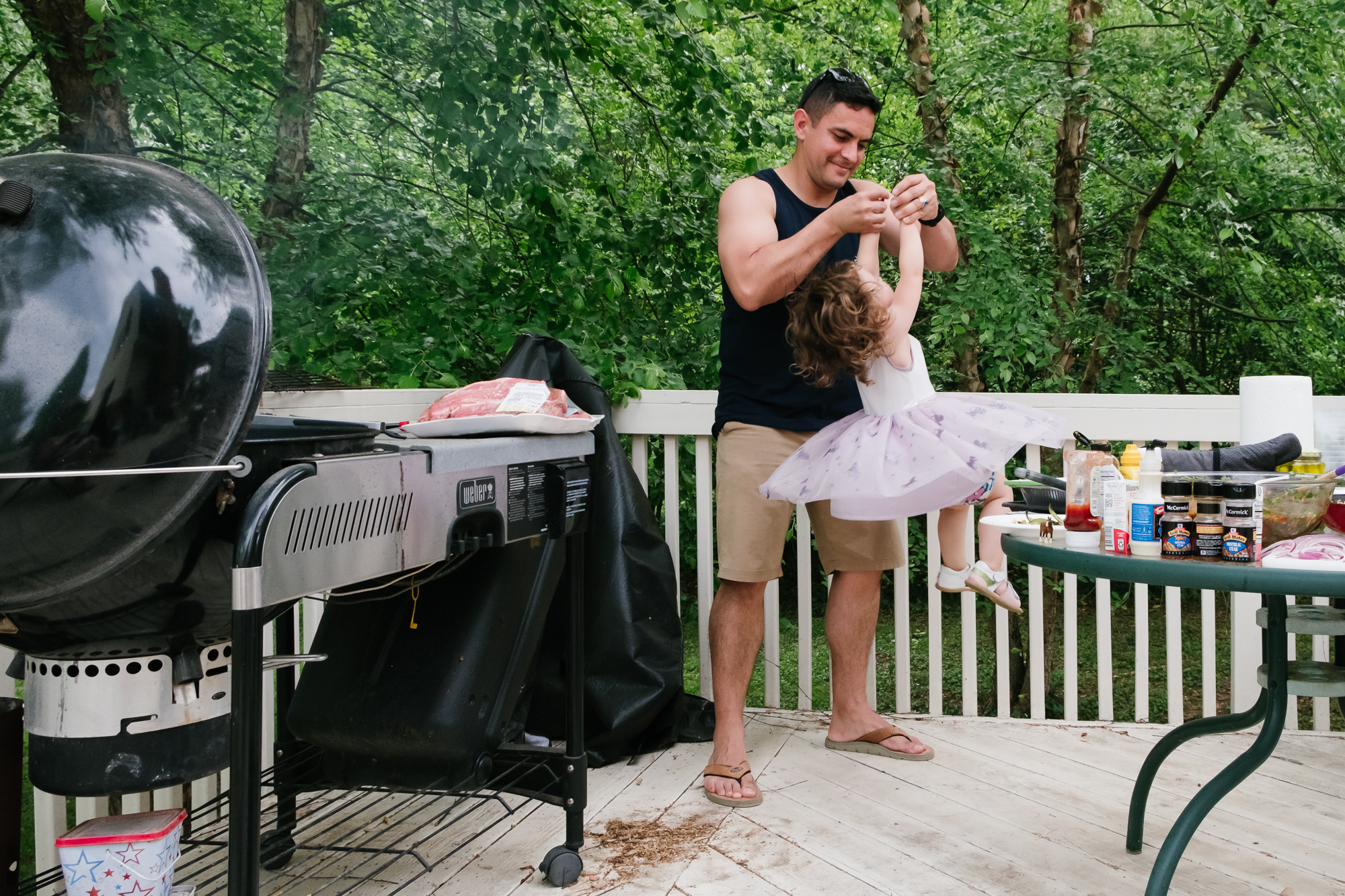 father lifting and spinning daughter - documentary family photography