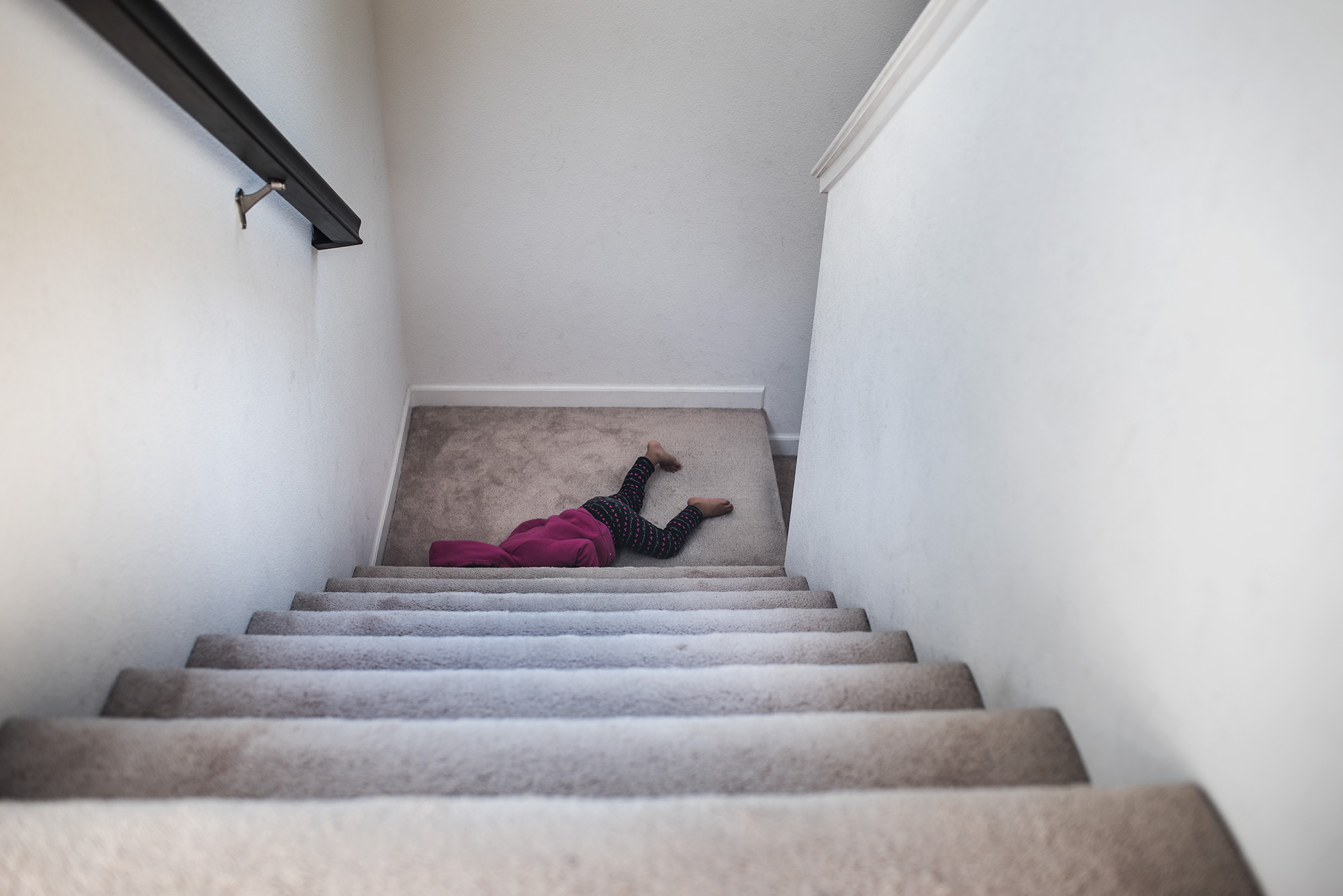 child at bottom of stairs - documentary family photography