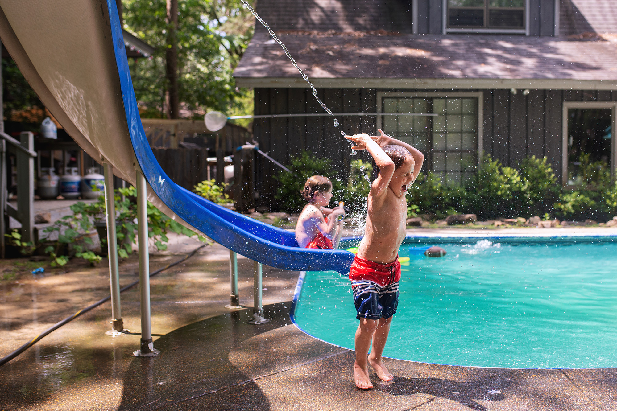 kids playing in pool - documentary family photography