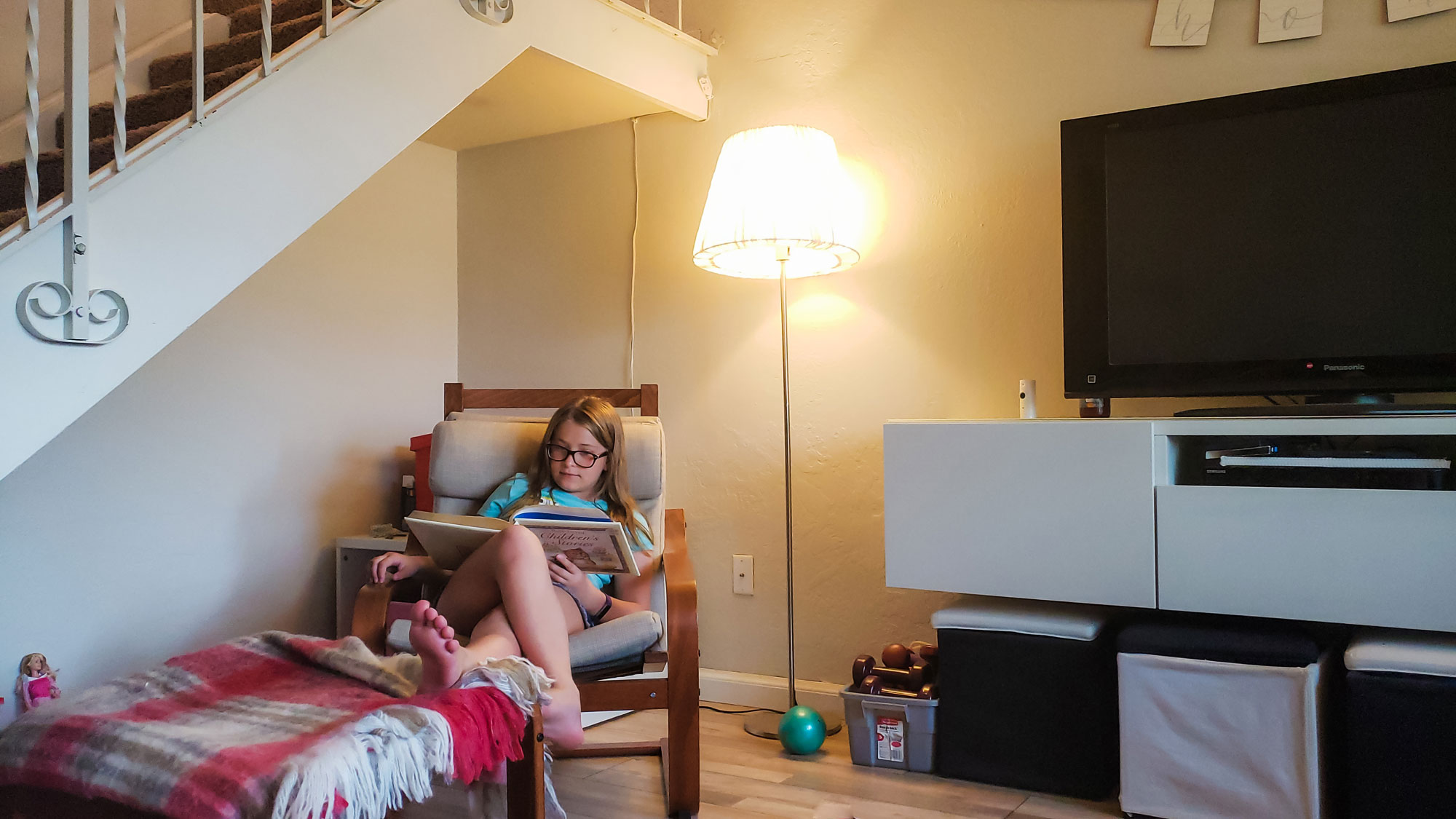 girl reading in chair - documentary family photography