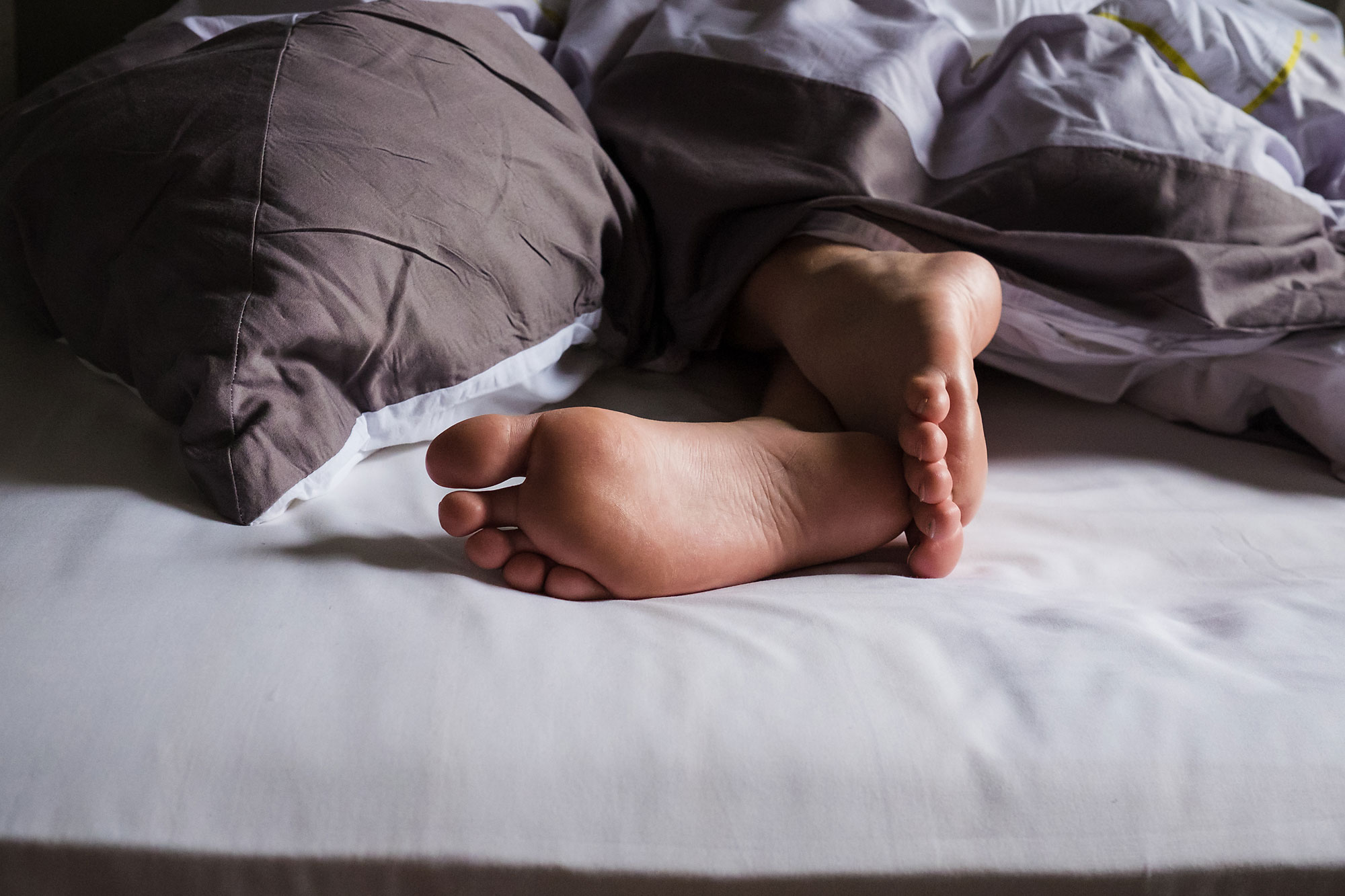 feet on bed - documentary family photography