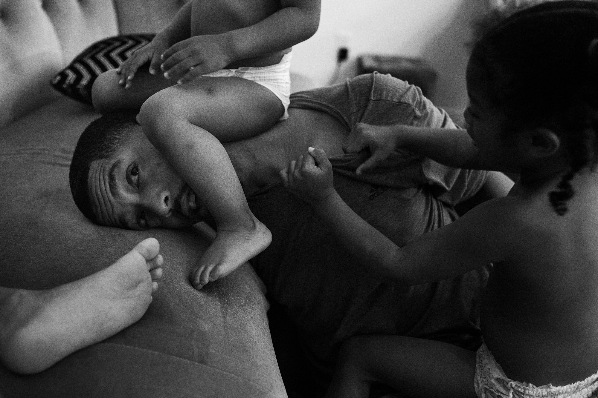 toddler sitting on father's head - documentary family photography