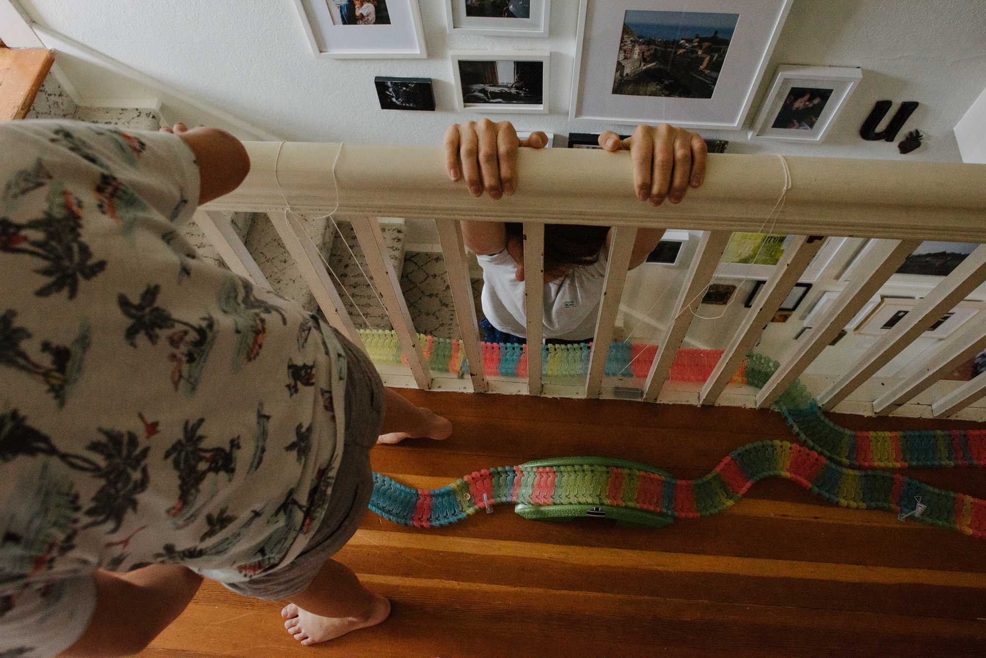 kid hanging on railing - documentary family photography