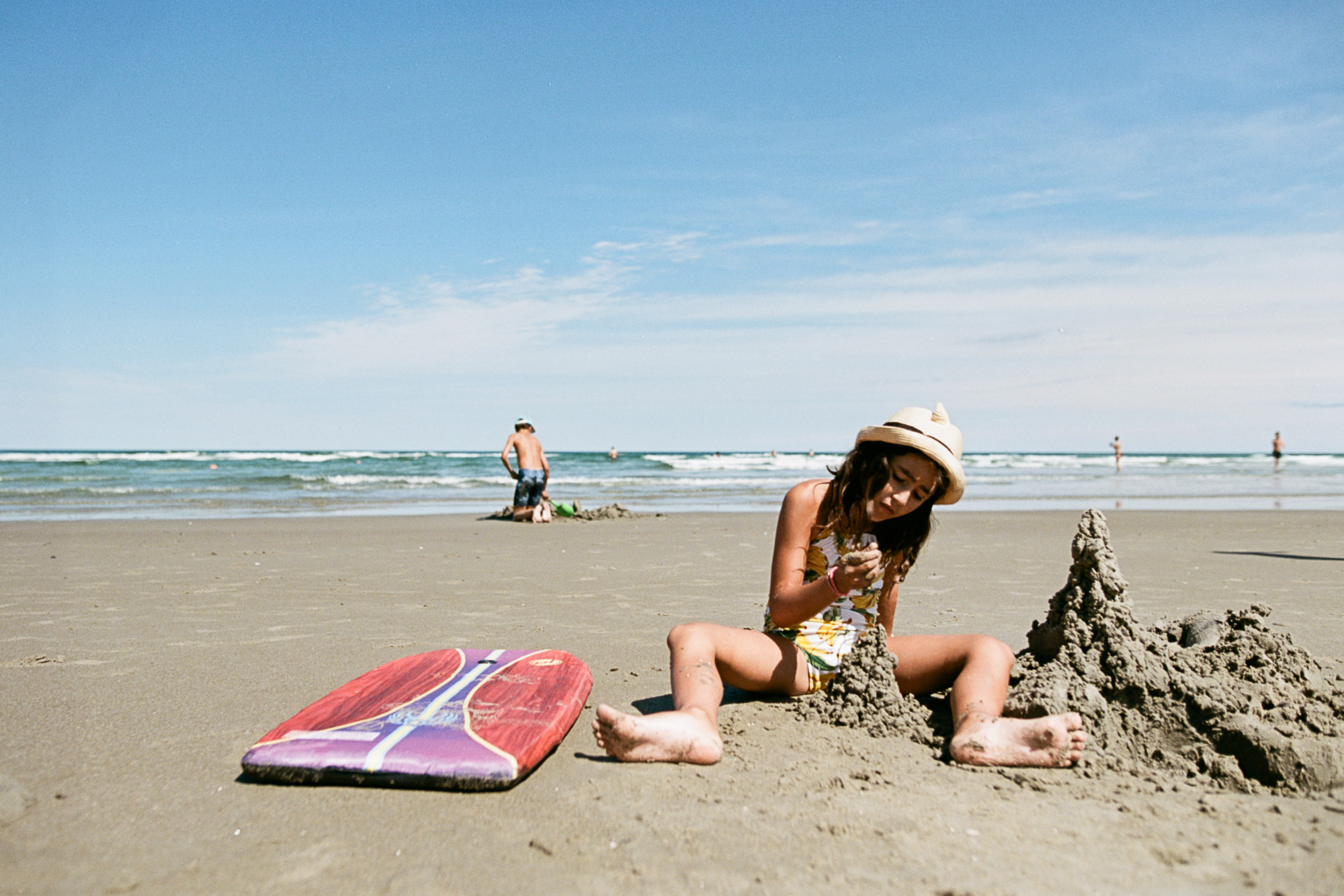 girl making sandcastle on beach - documentary family photography
