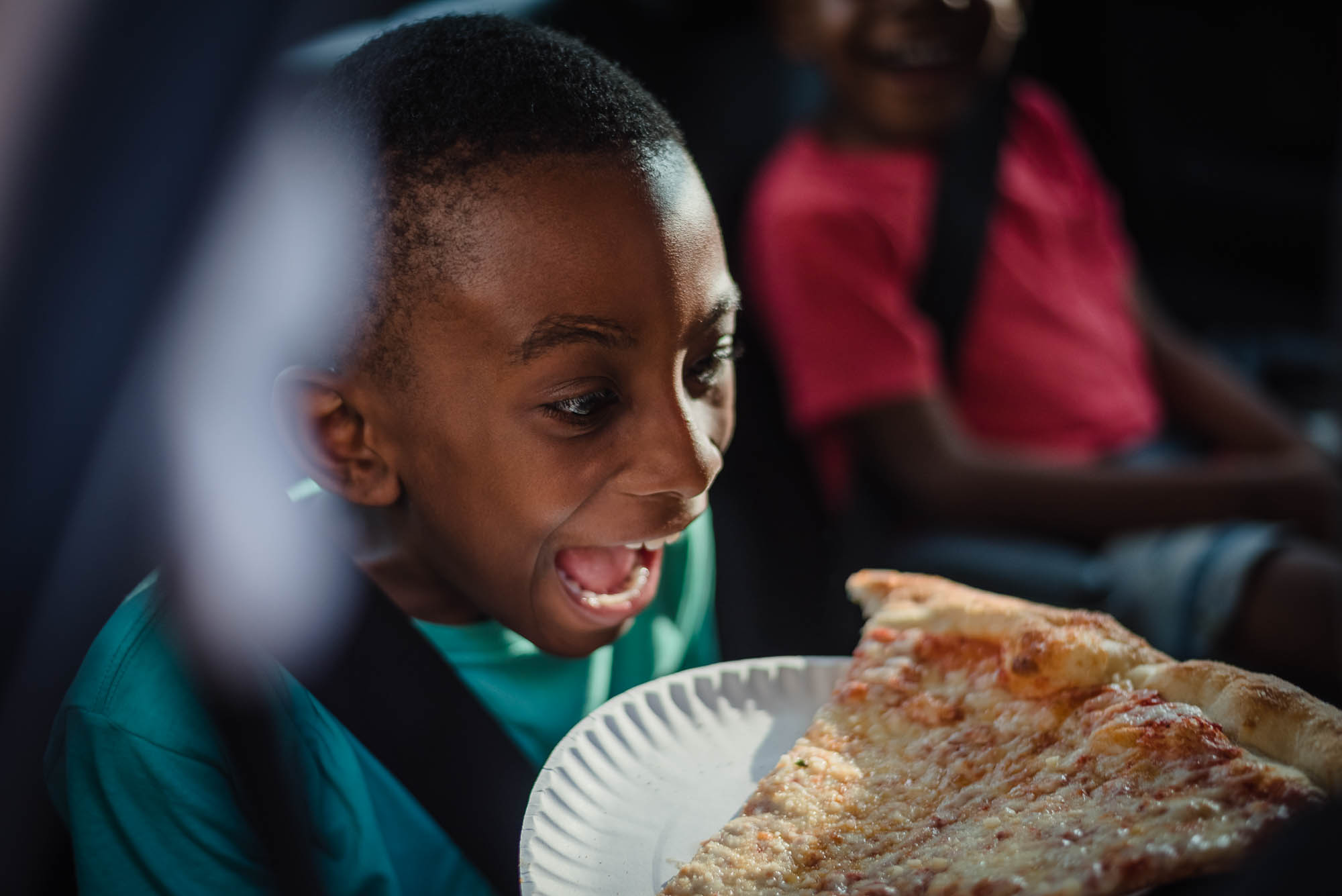 boy excited about pizza - documentary family photography