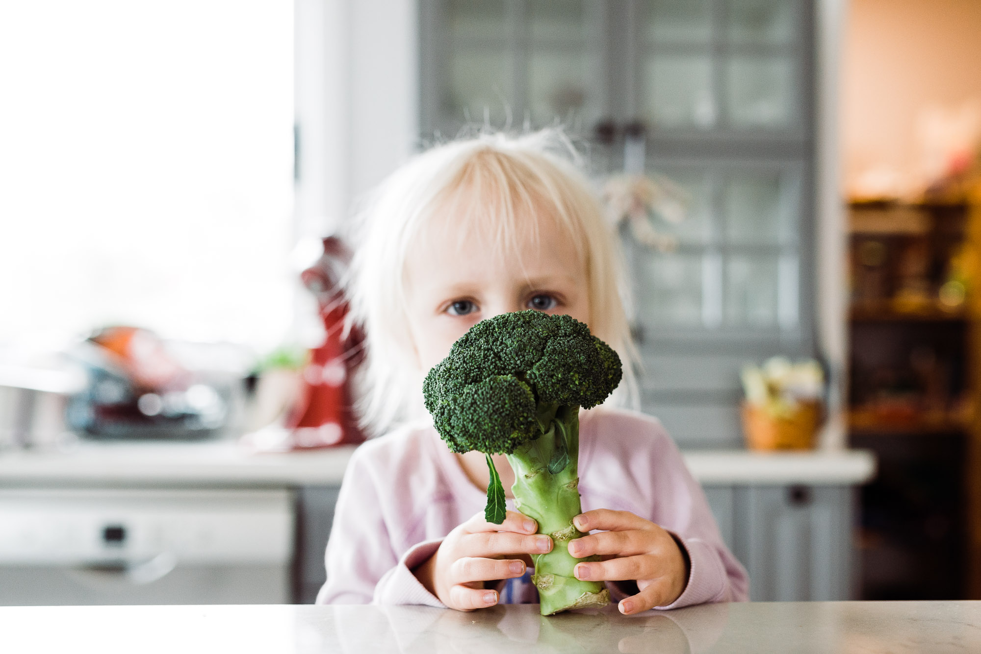 child with broccoli - documentary family photography