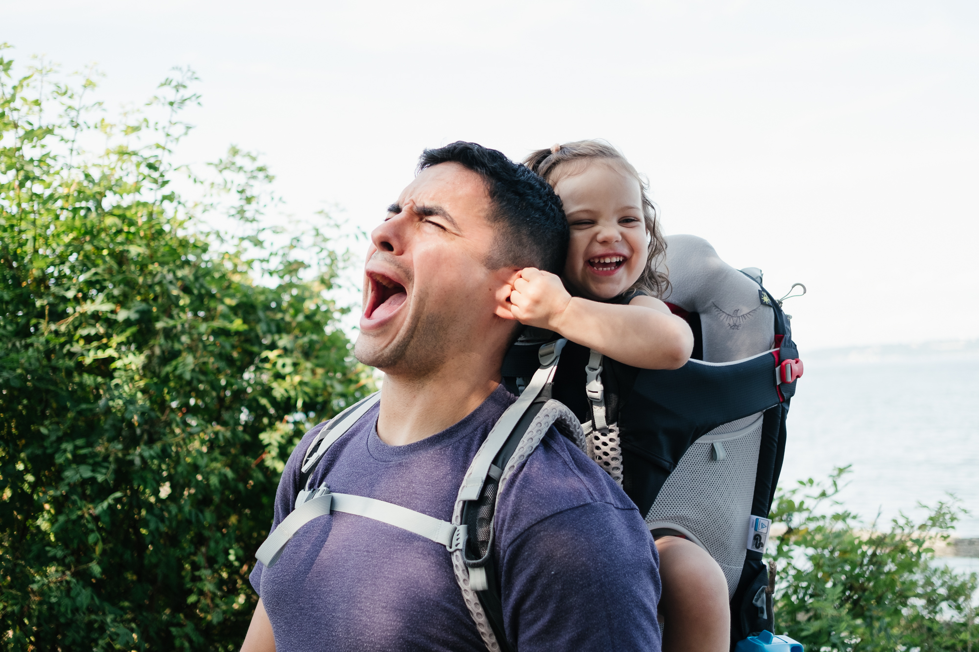 girl pulls on dad's ear - documentary family photography