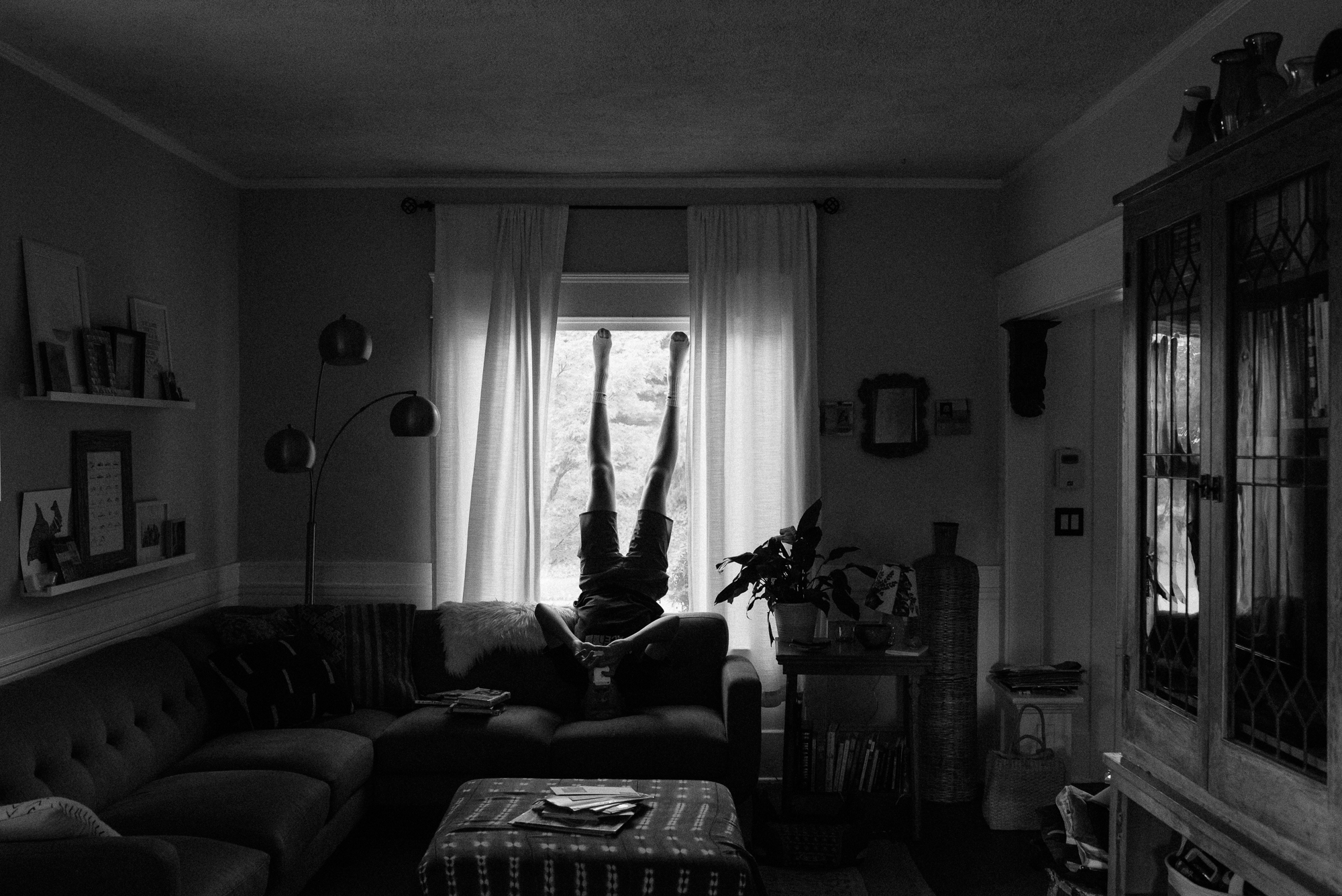 kid doing headstand on couch - documentary family photography