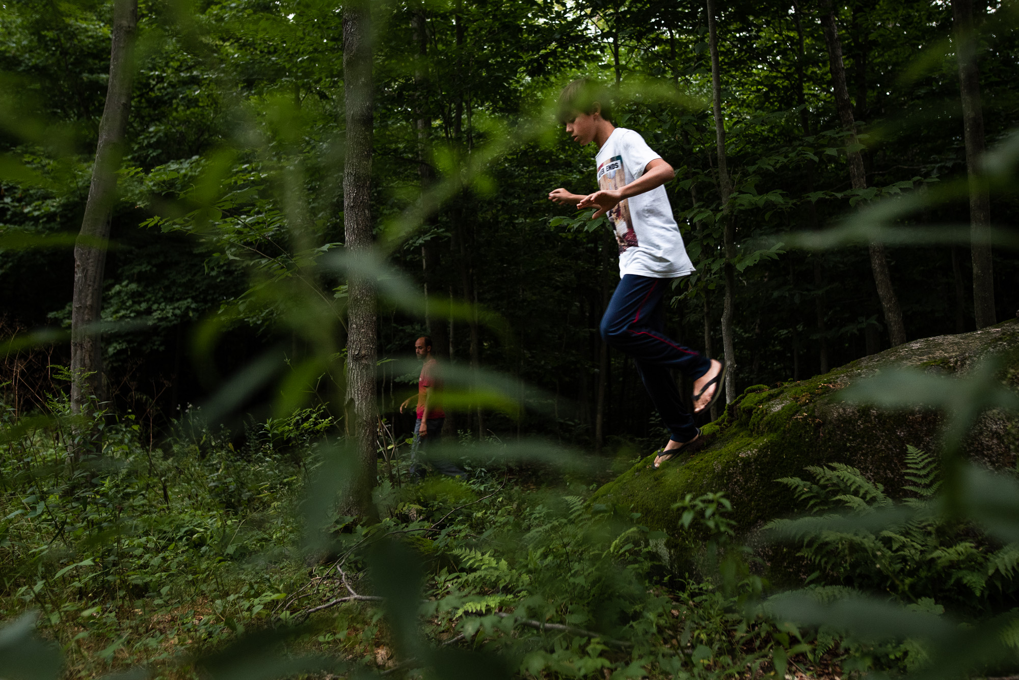 boy running through greenery - documentary family photography